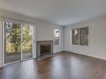 Large Living Room With Fireplace and Over sized Windows at Nickel Creek Apartments, 3702 204th St SW, 98036