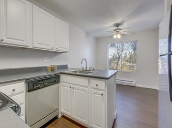Gourmet Kitchens with Islands, Caesarstone Countertops, and Decorative Backsplash at Nickel Creek Apartments, 3702 204th St SW, Washington