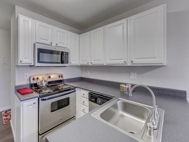Nickel Creek Apartments in Lynnwood Washington photo of updated kitchen with stainless steel appliances