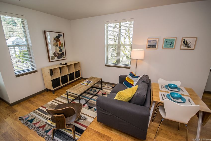 Apartments in Portland, OR - Living Room With Stylish Decor, Hardwood Flooring, and Access to Outdoor Patio - Photo Gallery 1