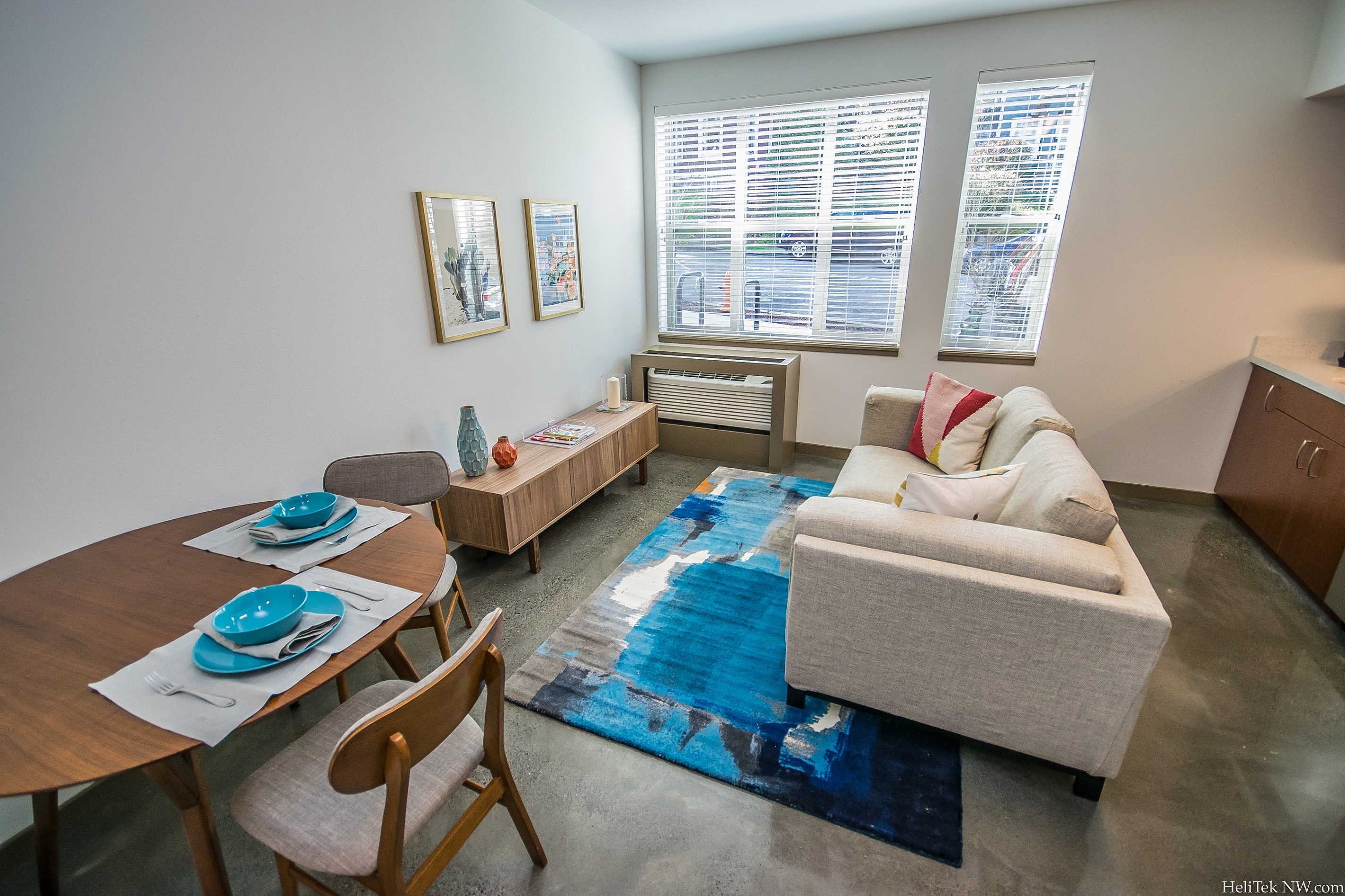 Apartments for Rent in Portland, OR - Corbett Heights - Spacious Living Room with Attached Dining Area, Large Windows, and Polished Concrete Flooring
