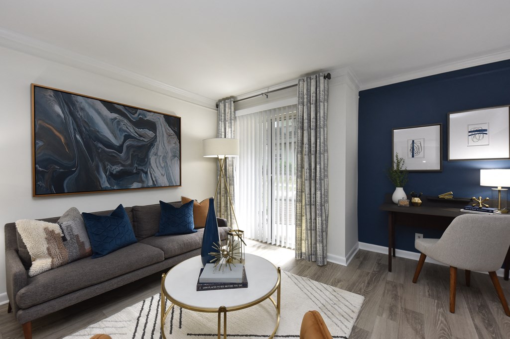 Bright living area with large windows at Vetra West End Apartments Nashville