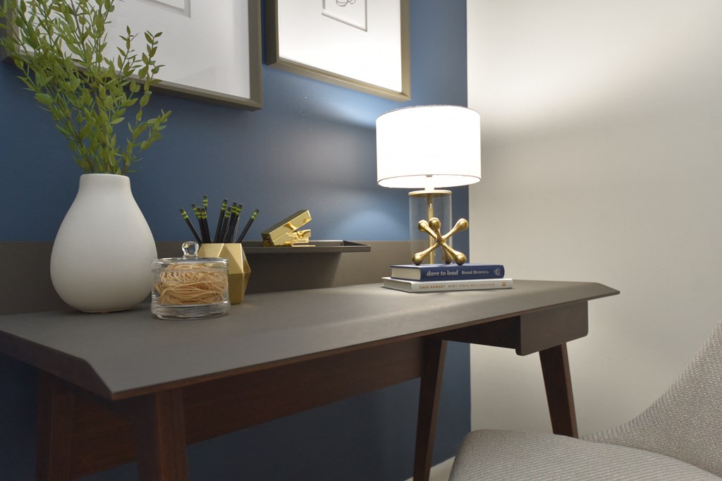Vetra West End, Nashville, TN apartments a desk with a lamp and a vase on it