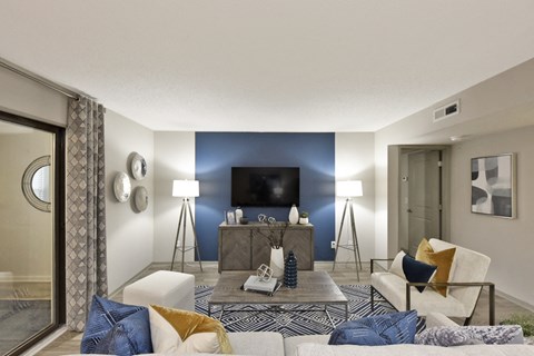 A living room with a white couch and a coffee table.