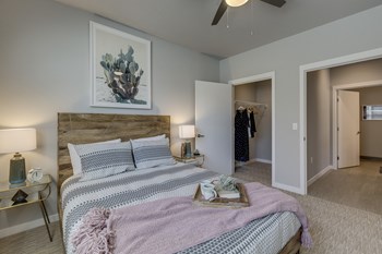 a bedroom with a bed and a ceiling fan - Photo Gallery 57