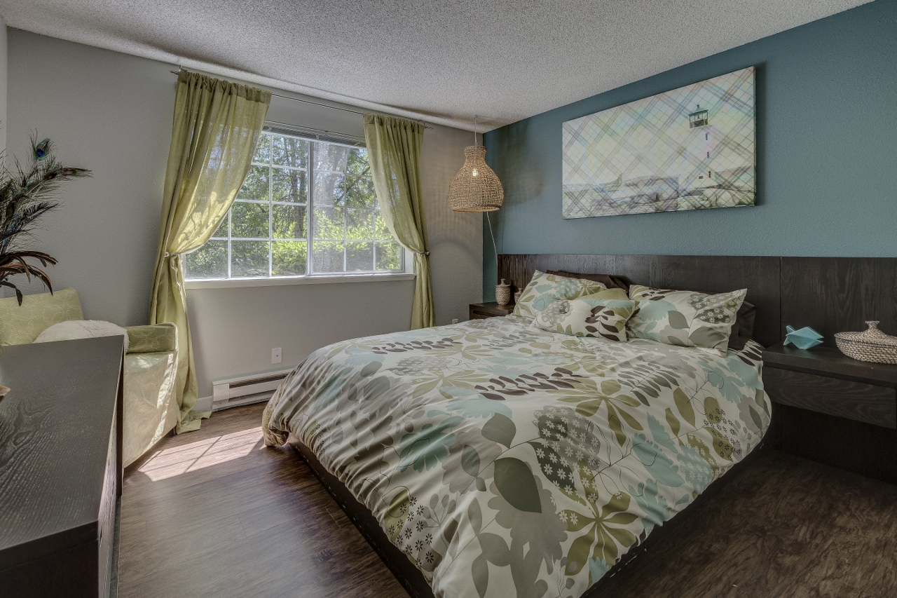 Apartments for Rent in Beaverton, OR - Cedar Crest - Spacious Bedroom with Large Window, Bed, Nightstand, and Dresser.