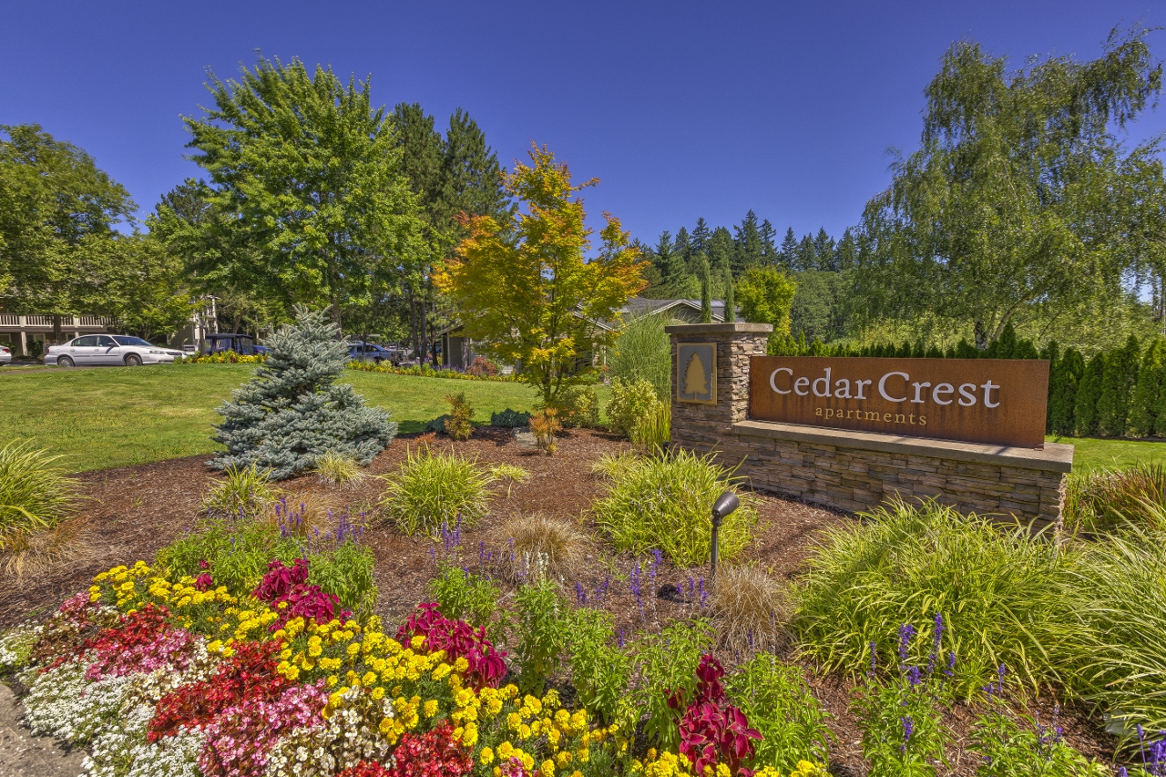 Apartments in Beaverton OR - Cedar Crest - Front Entrance Sign Surrounded by Lush Landscaping