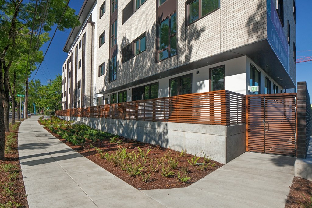 a large building with a wooden fence in front of it