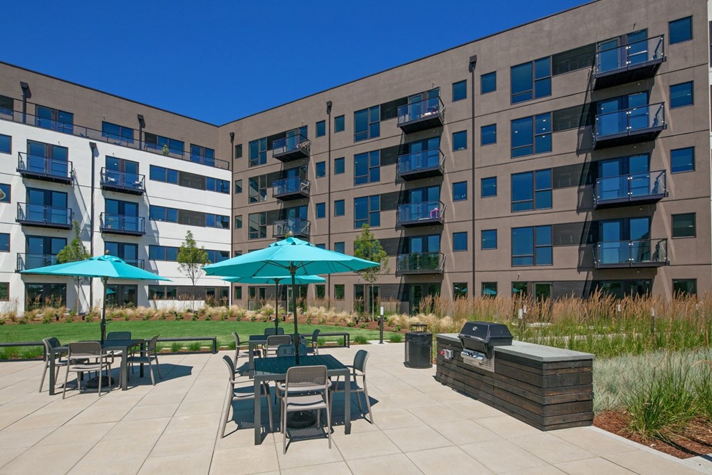 an outdoor patio with umbrellas and tables