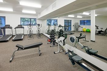a room filled with lots of different types of exercise equipment
