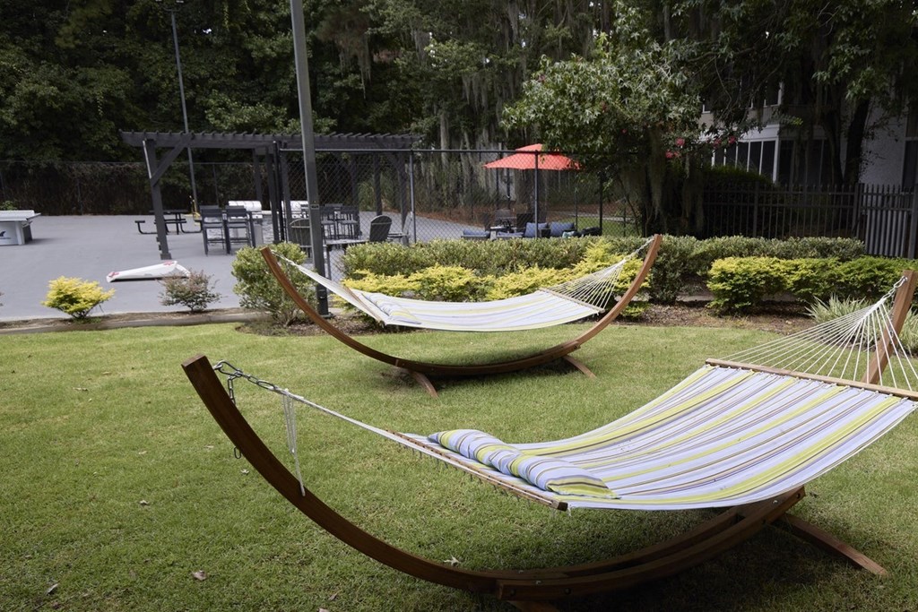 Greentree Apartments in Savannah, GA photo of two hammocks on the lawn in a garden