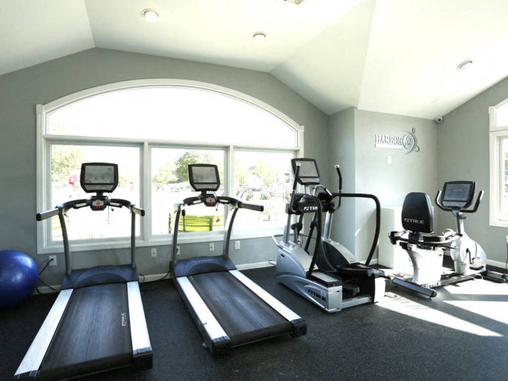 a gym with treadmills and other exercise equipment