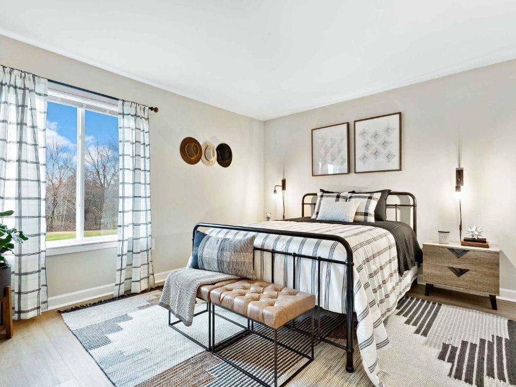 a bedroom with a bed and a window