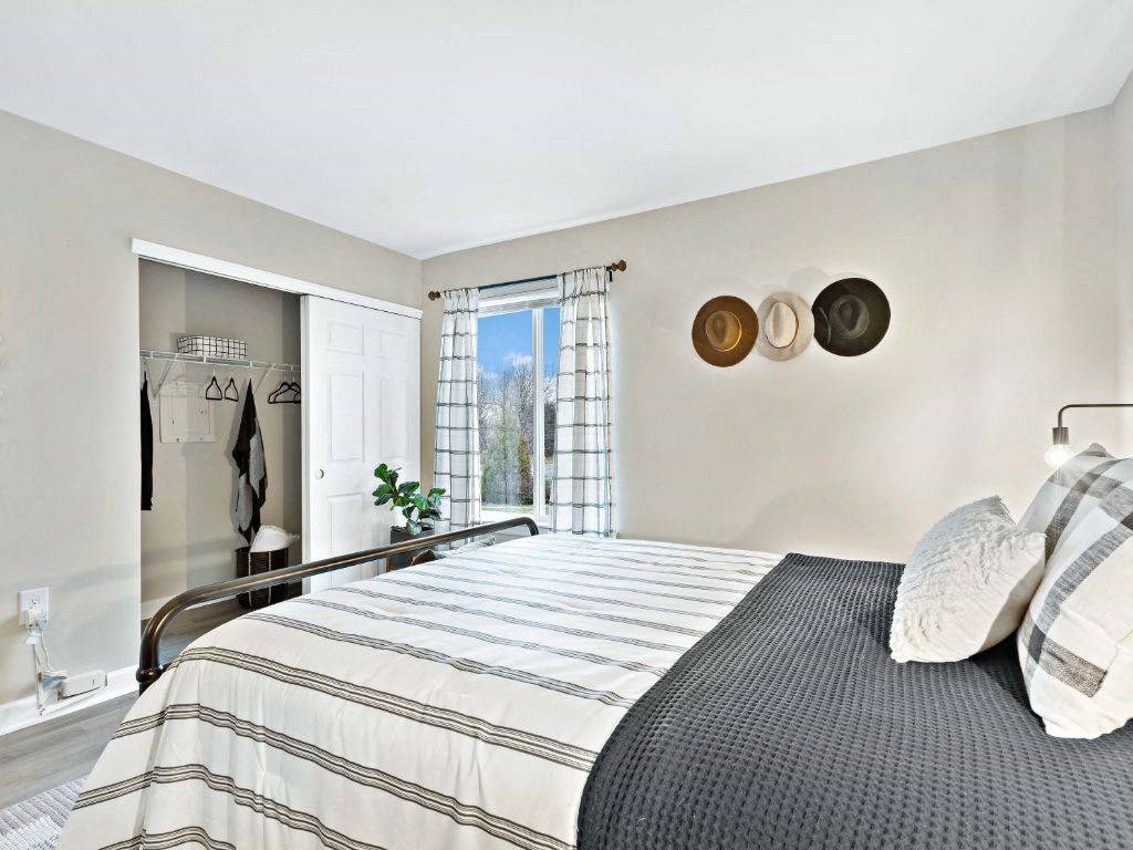 a bedroom with a bed and a window