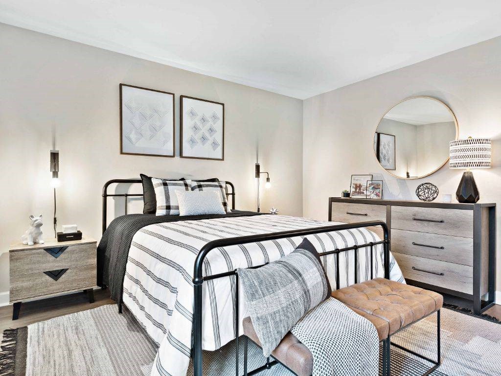 a bedroom with a bed and a mirror