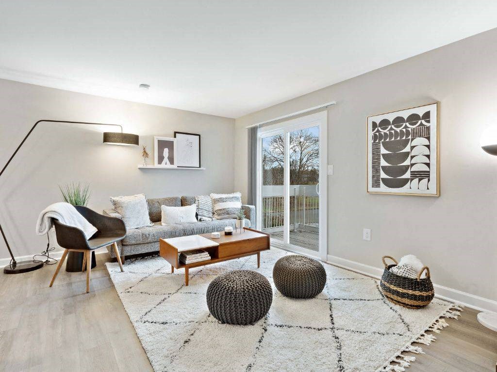 a living room with a couch and a sliding glass door