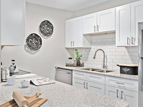 a kitchen with white cabinets and a counter top
