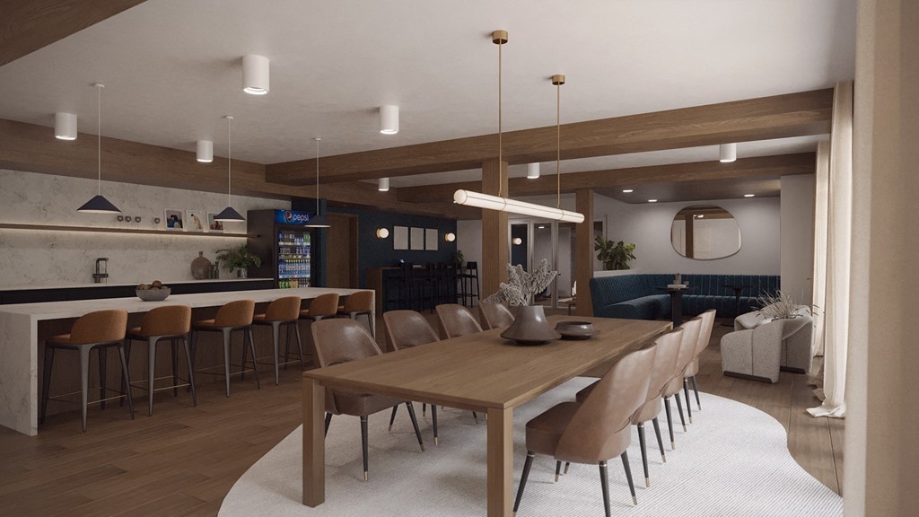1 Bedroom Luxury Apartments in Vancouver, WA - Adera - Clubhouse with Kitchen Area, Tables, Chairs, Modern Light Fixtures, a Vending Machine, Storage Shelves, and Upscale Finishes