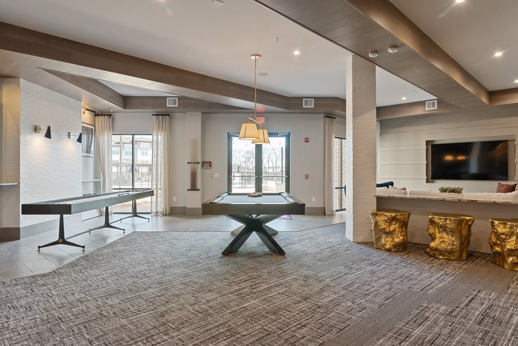a game room with a ping pong table and a flat screen tv