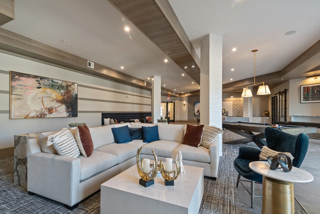a living room with couches and tables and a fireplace