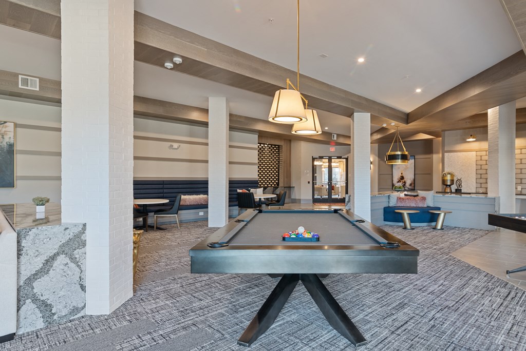 a pool table in the lobby of a club with pillars