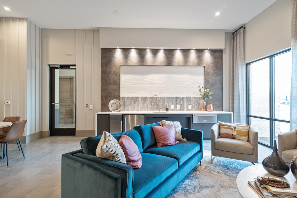 a living room with a blue couch and a table