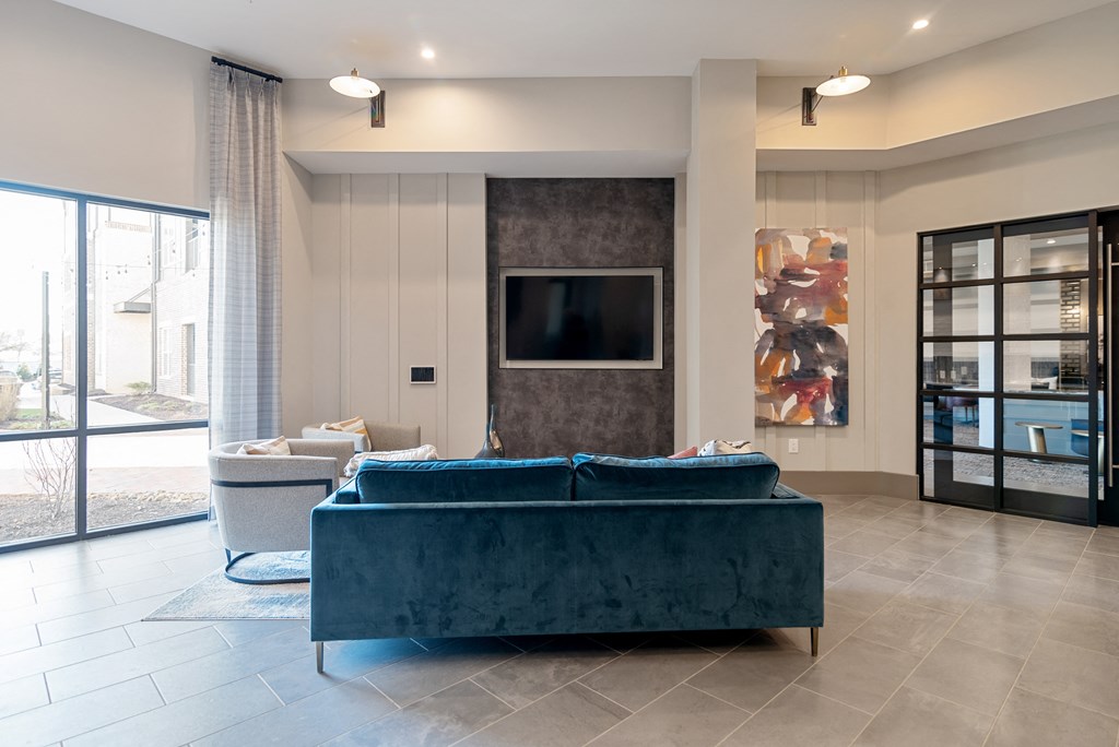 a living room with a blue couch and a television