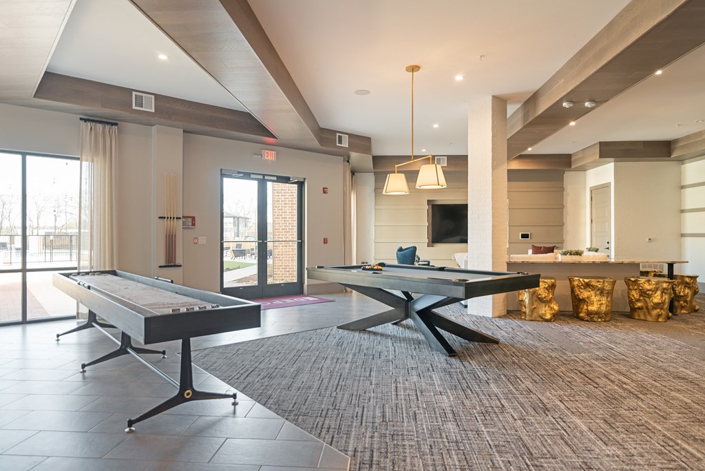 two ping pong tables in the center of a living room