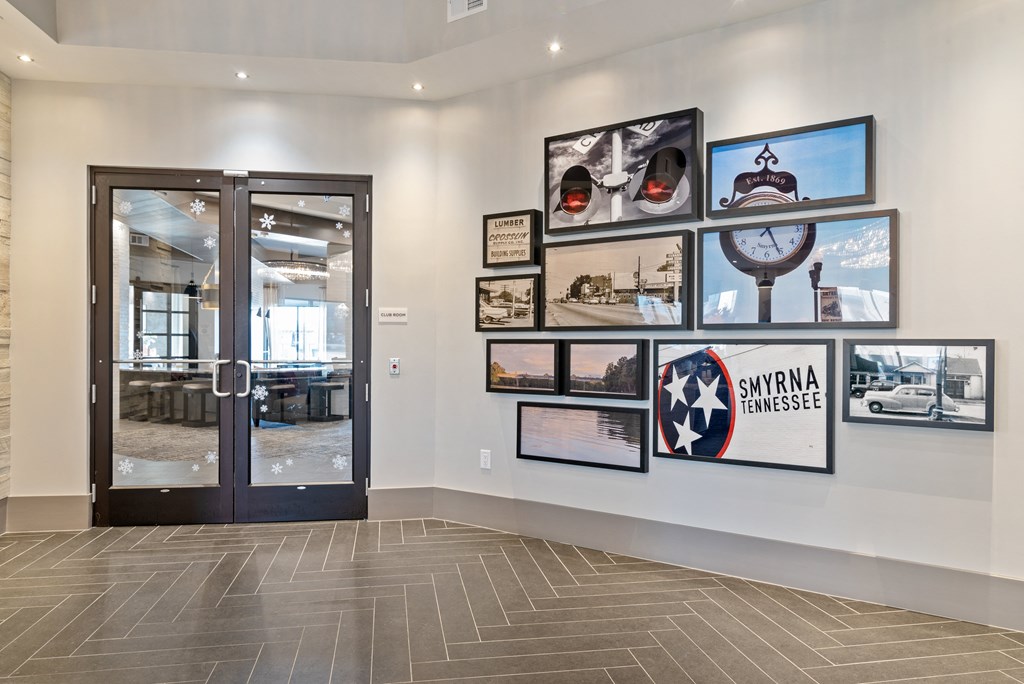 the lobby of a building with various pictures on the wall