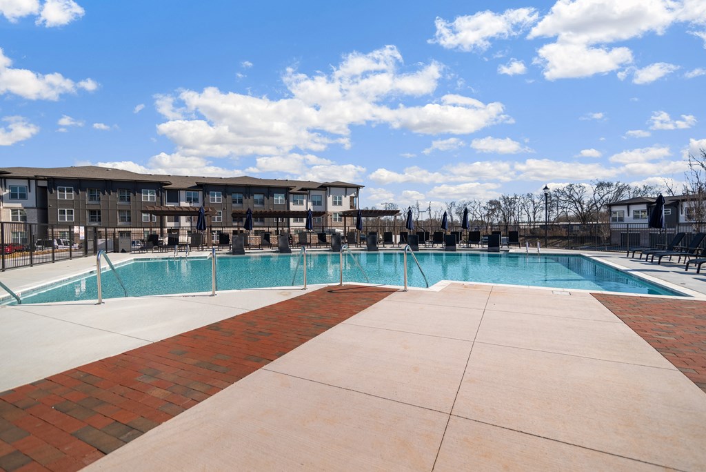 a large swimming pool with a building in the background