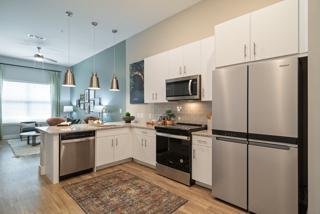 a kitchen with stainless steel appliances and white cabinets