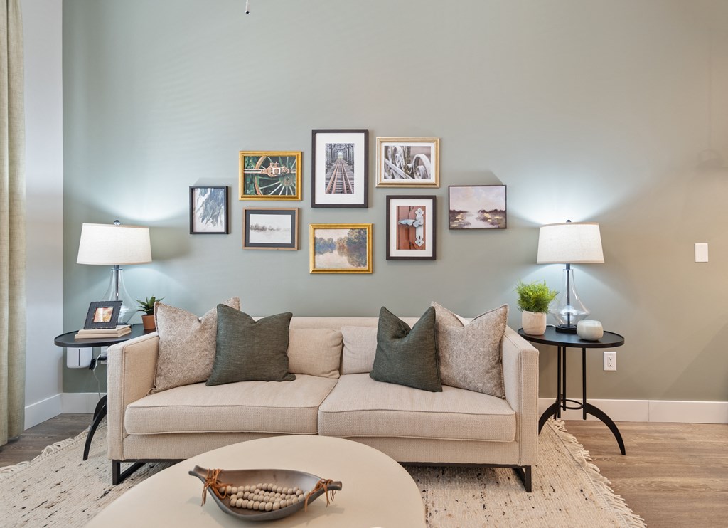 a living room with a couch and a wall of pictures