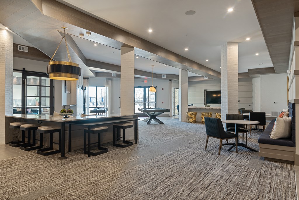 a large living room with a large table and chairs