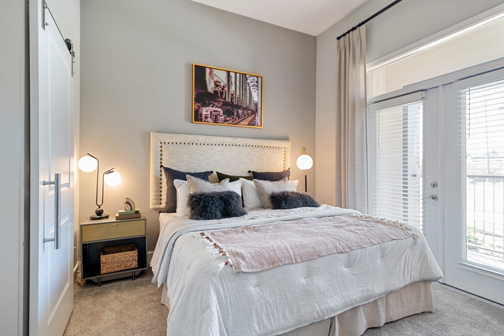 a bedroom with a large bed and a window