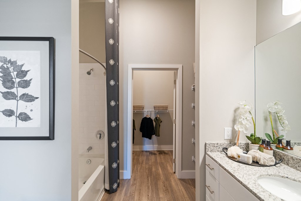 a bathroom with a shower and a sink and a mirror