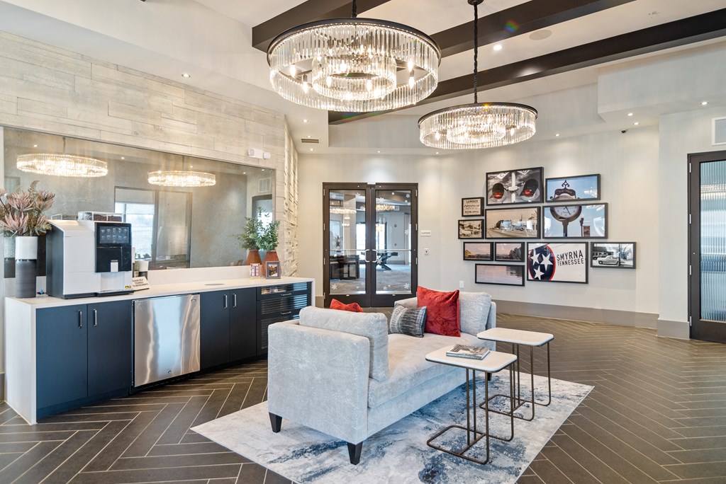 a living room with a couch and a kitchen