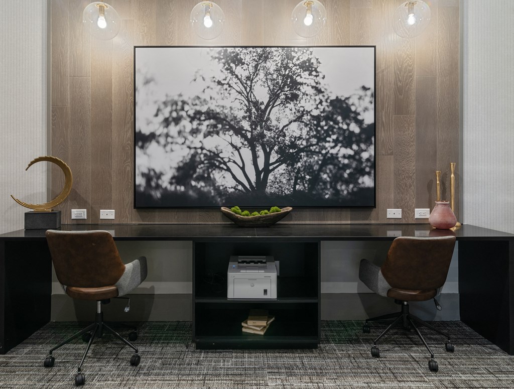a living room with two chairs and a table with a television on it