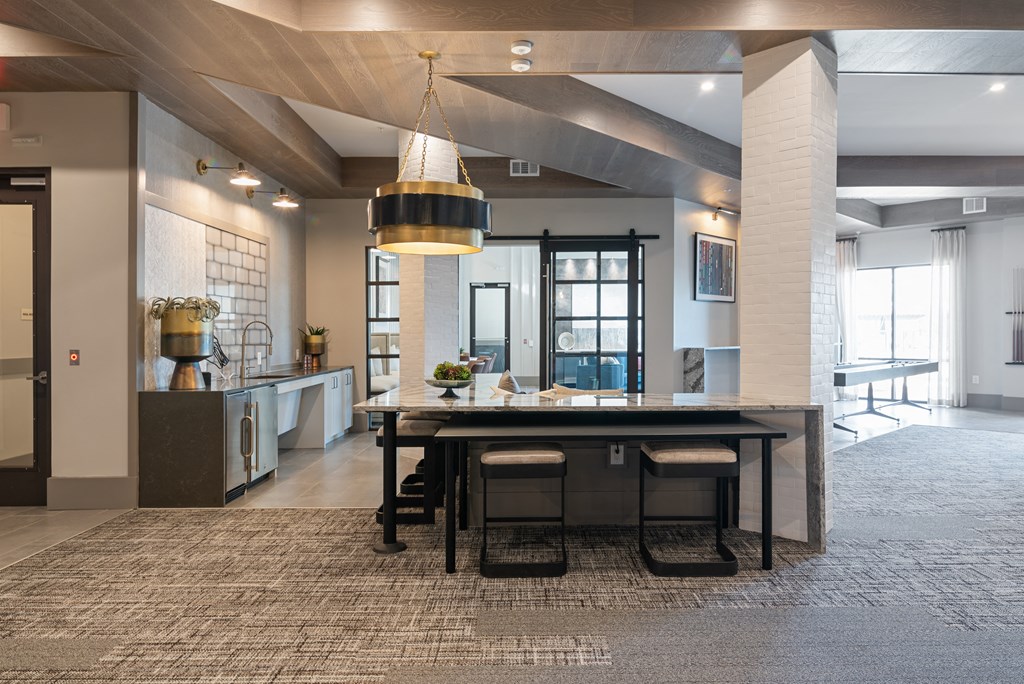 a dining room and kitchen with a large table and chairs