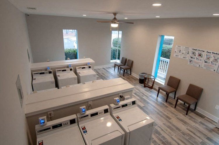 an empty room with a row of washing machines