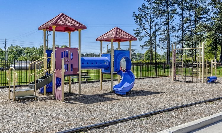 a playground with a bunch of slides and a swing set