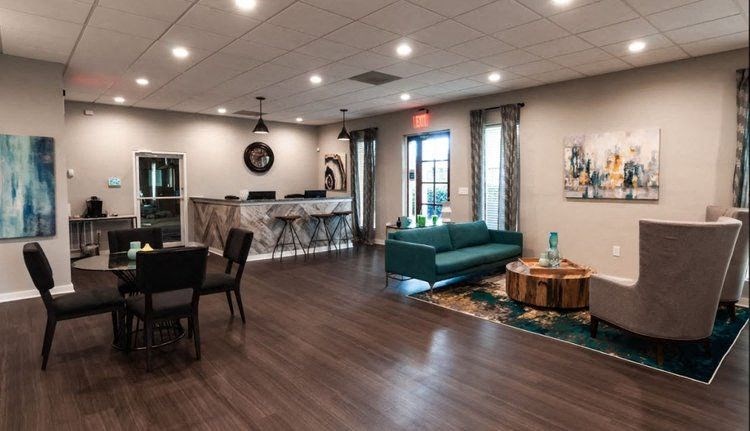a living room and dining room with a table and chairs