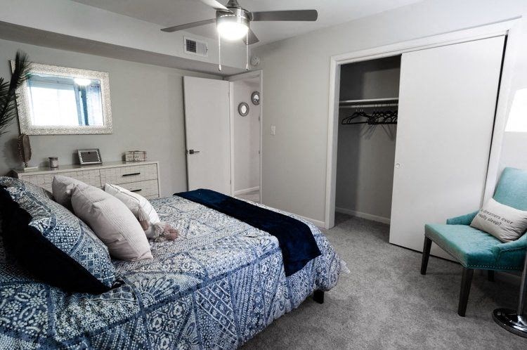 a bedroom with a bed and a closet