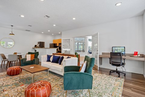 A living room with a green chair and a white couch.