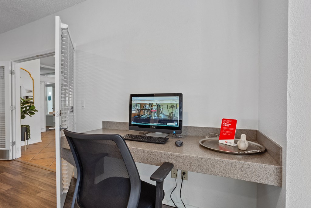 A black chair is in front of a desk with a computer and a mouse. at Cedar Crest, Oregon