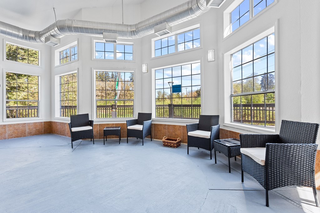 A room with a lot of windows and chairs. at Cedar Crest, Beaverton