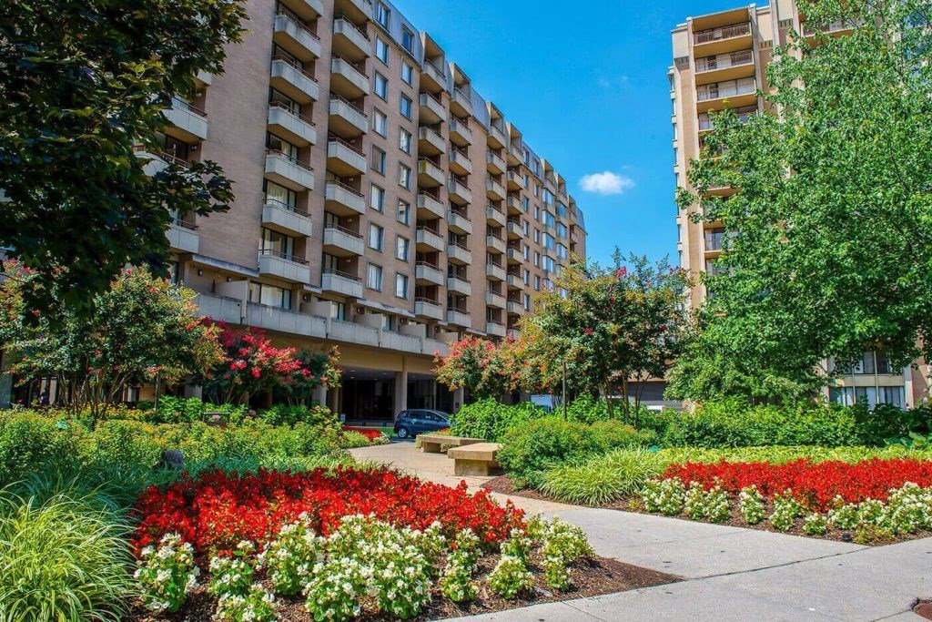 A building with a garden in front of it.