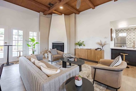 A living room with a grey sofa and a black coffee table.