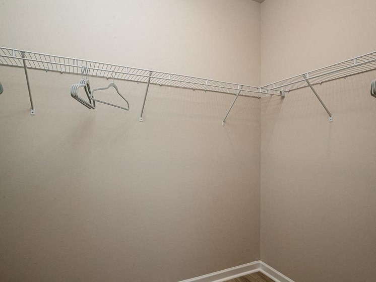 a walk in closet in a bedroom