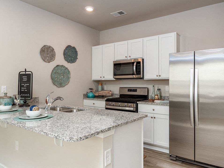 a kitchen with a counter top and a refrigerator