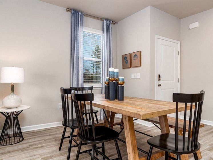a dining room with a table and chairs